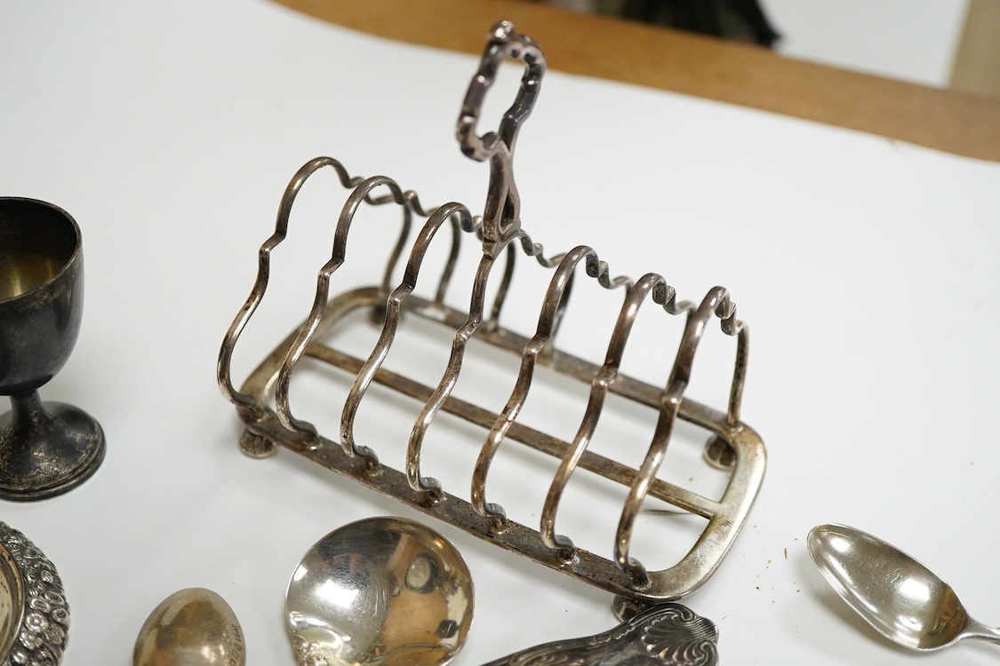 A collection of small silver, to include a late Victorian seven bar toast rack, by Edward Gilbert, London, 1887, length 13.3cm, a late Victorian bowl, pair of shell salts, nut dish, egg cup, Georgian chamberstick(part of